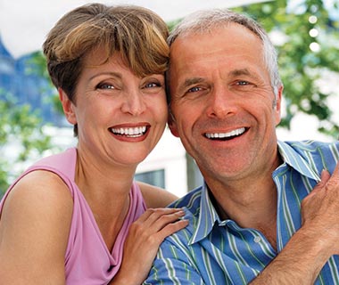 Happy couple in 60s outside