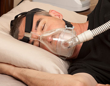 Man sleeping with a CPAP mask