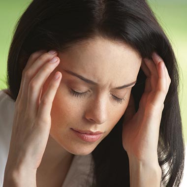 Woman holding head suffering from headache