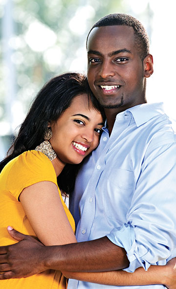 Couple embracing comfortably and smiling
