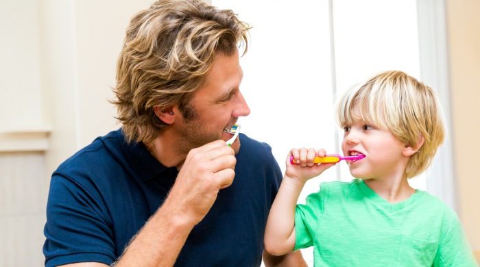 dad and son brushing teeth