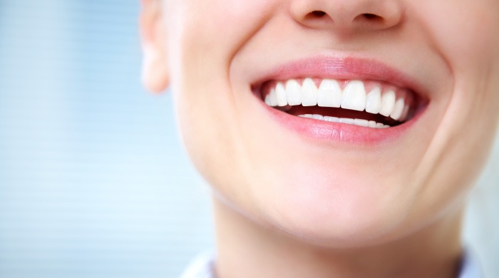 woman with healthy smile knows symptoms of gum disease