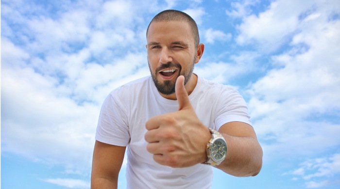 man giving a thumbs up to the durability of his CEREC dental crowns