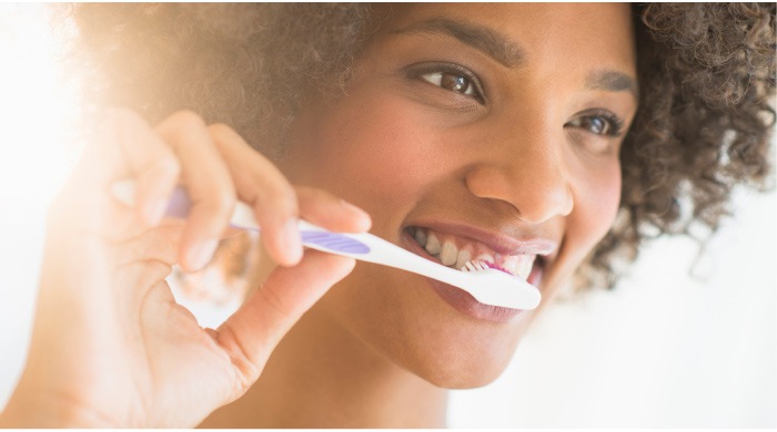 girl brushing her teeth