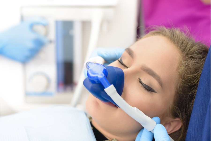 woman in the dentist's chair undergoing sedation dentistry to relieve anxiety