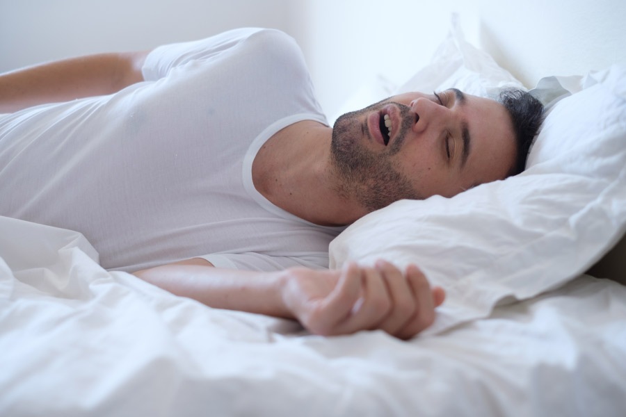 sleeping man grinding his teeth at night