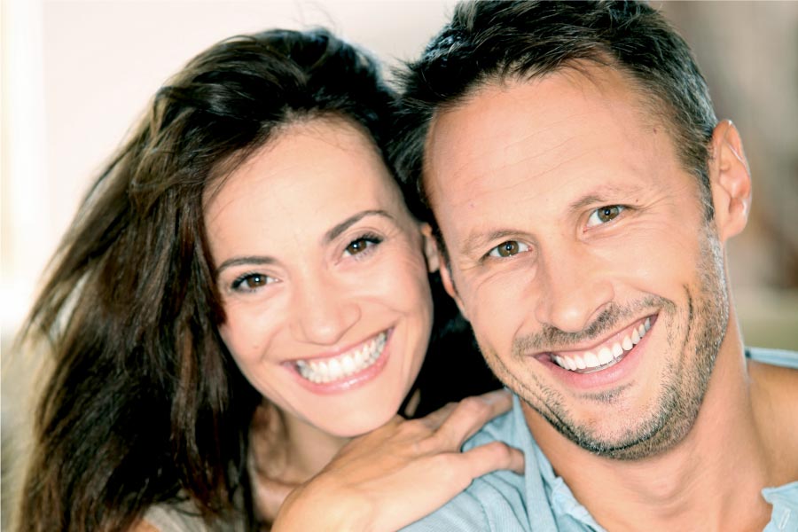 young couple smile showing off their white teeth