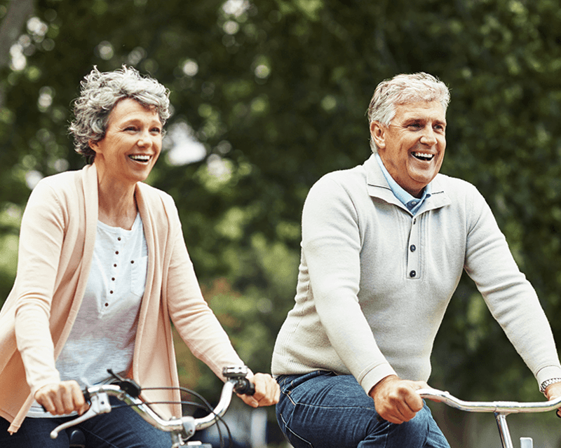 Older couple bicycling together